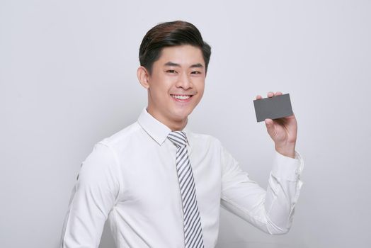 portrait of young asian man showing a visit card