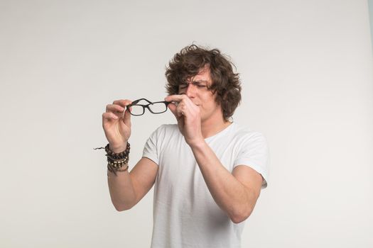 Portrait of young man wearing eye glasses in studio.