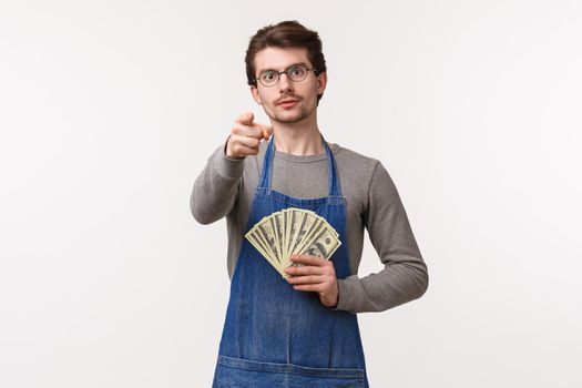 Small business, finance and career concept. Portrait of serious-looking young determined guy telling you secret how to earn money, become rich on your enterprise, hold cash and point camera