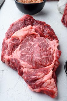 Raw fresh marbled meat Steak Ribeye Black Angus, on white stone background, top view flat lay