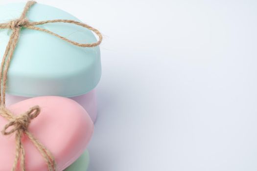 Two pieces of soap tied with a ribbon on a white background