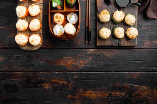 Fresh Sushi rolls with wasabi and ginger, on old dark wooden table background, top view flat lay , with copyspace and space for text
