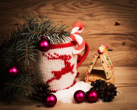 Christmas mug with Christmas decorations on wooden background