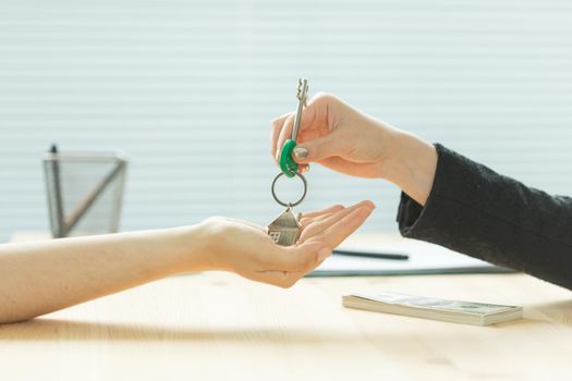 Business, realtor and real estate concept - Hand-to-hand key from new home