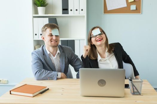 Business, break and people concept - Cheerful man and woman playing games in office while working