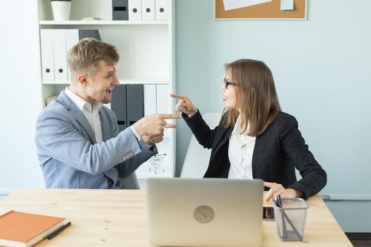 Business, break and people concept - Cheerful man and woman playing games in office while working