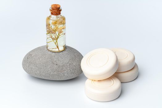Spa stones and soap on white background, close up