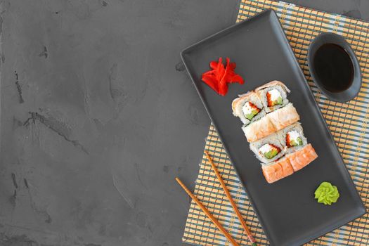 Sushi roll with shrimp on gray background top view