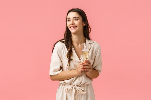 Elegance, romance and tenderness concept. Charming pretty brunette woman in lovely dress contemplating beautiful wedding ceremony, being guest party, holding glass champagne and smiling.