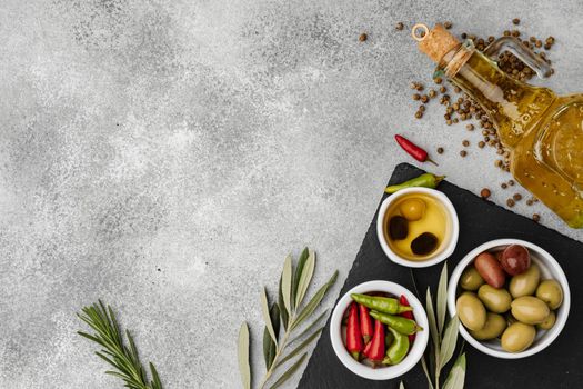 Olives and spices on a gray stone background