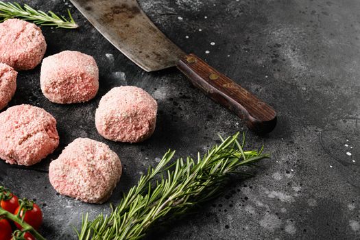 Semi-finished products, raw meatball, on black dark stone table background, with copy space for text