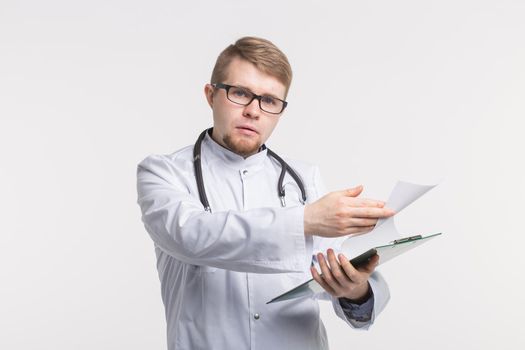Medicine and health concept - doctor with stethoscope holding document folder on white background