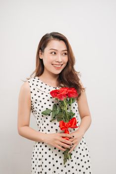 Is it for me. Waist up portrait of joyful young lady receiving red rose