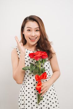 Is it for me. Waist up portrait of joyful young lady receiving red rose