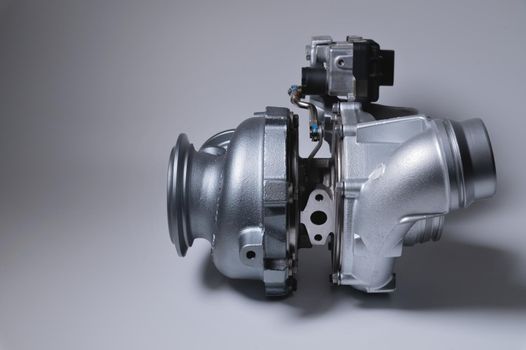 New metal turbocharger. Exhaust gas blower. Parts background