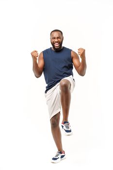 Young fitness african black man in sport wear cheering carefree and excited. Victory concept