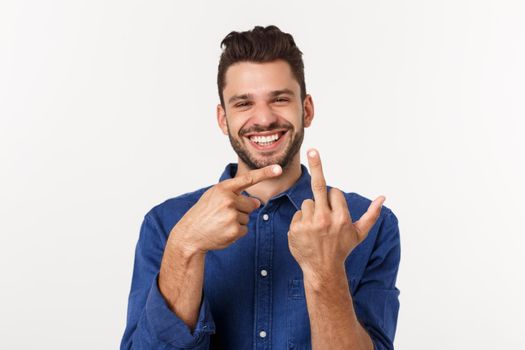 Handsome young man showing middle finger gesturing Screw you with white background.