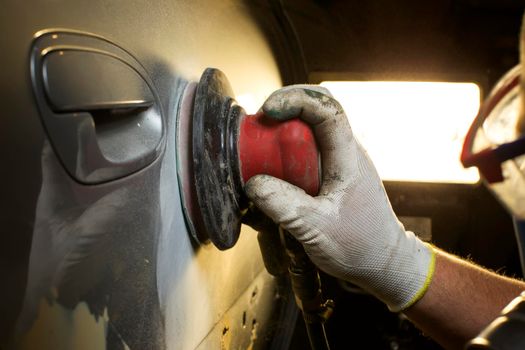 Hands grind polish the car. Car body repair