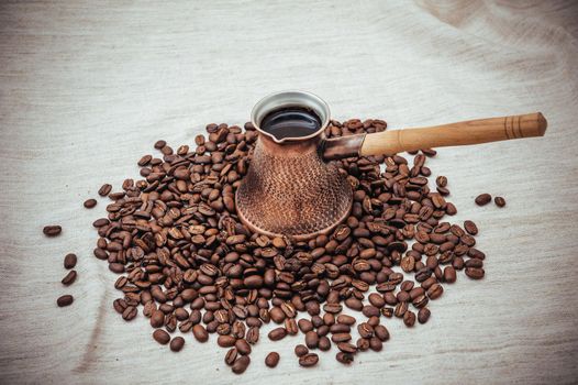 Coffee turk on burlap background. coffee beans isolated on white background. roasted coffee beans