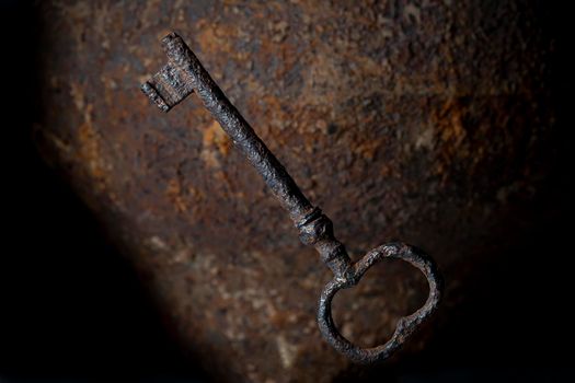 Vintage key on rusty background close up