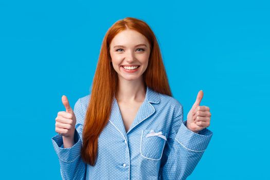 Fine, you alright. Pretty satisfied female with red long hair wearing nightwear, finished taking-off makeup using daily routine skincare products, recommend discount, blue background