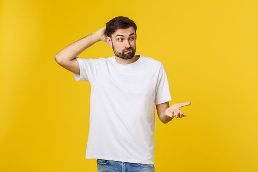 Worried young man standing isolate on yellow wall