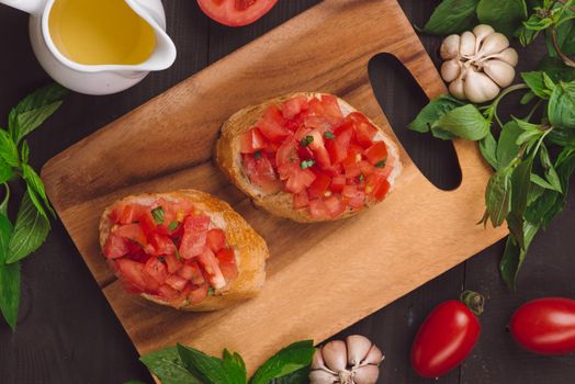 Appetizer bruschetta with tomatoes, olives and herbs. Italian cuisine