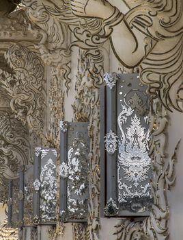 Elaborate sculptures of windows at the famous Wat Rong Khun.