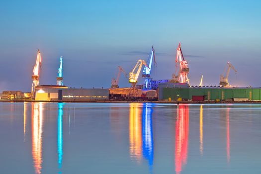 City of Pula shipyard illuminated cranes evening view