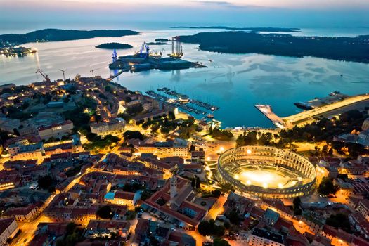 Arena Pula. Ancient Roman amphitheatre and bay of Pula aerial evening view