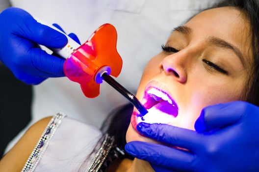 Close-up portrait of a female patient visiting dentist for teeth whitening