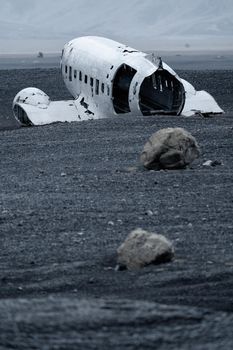 Wreck of and airplane rear view with huge stones