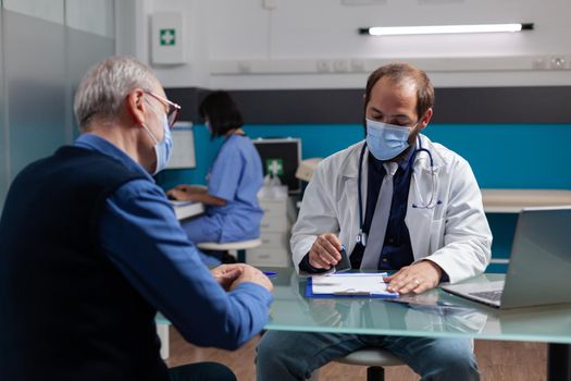 Practitioner putting medical seal on prescription paper