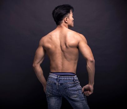 Rear view of  muscular asian young man