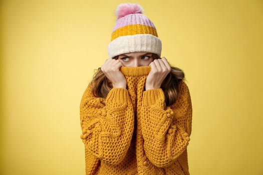 Offended sad whining cute tender young girl hiding face pull sweater nose peek look aside insulted complaining being insulted, standing miserable upset wearing warm winter corduroy hat