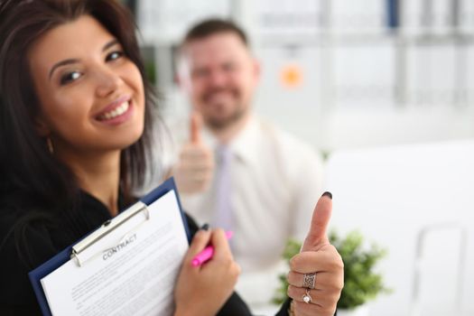 Female hand showing thumbs up OK gesture at meeting