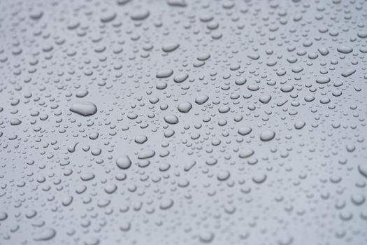 Small droplets of water on a matte gray background