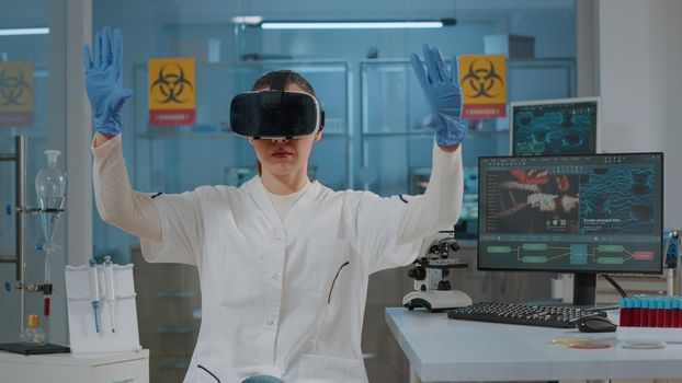 Woman biologist using vr glasses in science laboratory