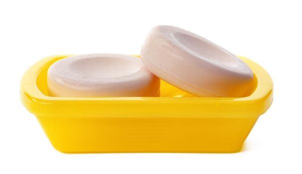 Soap on a plastic soap dish isolated on a white background