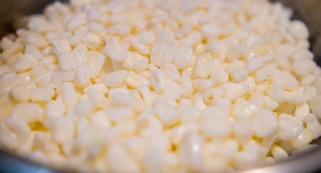 Close-up of uncooked corn kernels in cooking pot