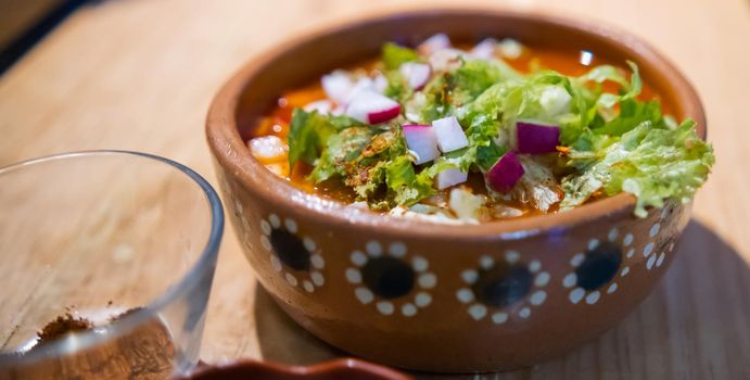 Clay bowl of delicious and traditional Mexican pozole