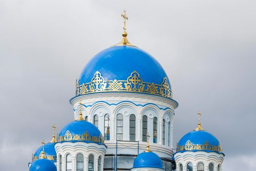 Orthodox Church in Russia Siberia. Gray sky.