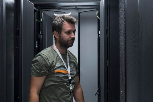 IT engineer working In the server room or data center The technician puts in a rack a new server of corporate business mainframe supercomputer or cryptocurrency mining farm.
