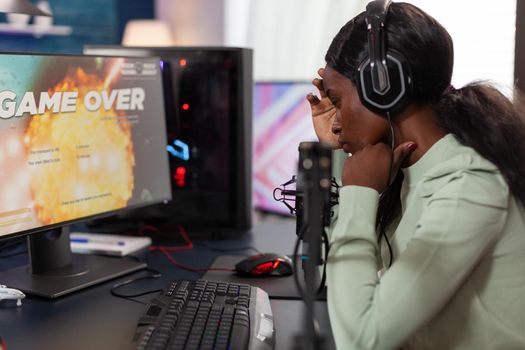 Sad upset woman gamer playing space shooter videogames