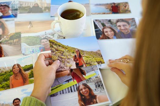 Young woman watching at her printed photos, remember nostalgia for a day of rest