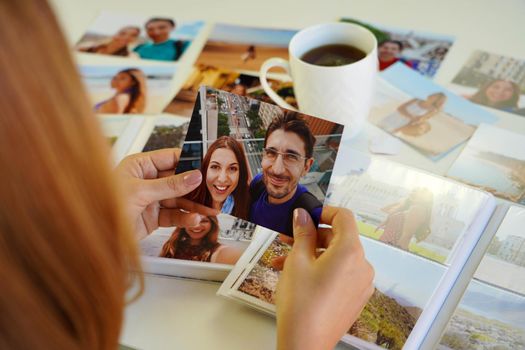 Romantic woman looking at image prints with her boyfriend at home