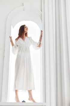 woman in the form of an angel barefoot in the luxury window