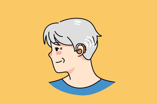 Old man with hearing kit in ear
