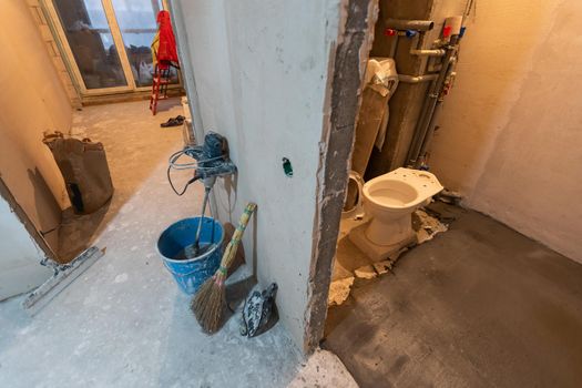 Toilet bowl in the bathroom. Repair. Sanitary ceramics. Plumbing. Water pipes. Plastic faucet. Floor standing toilet.