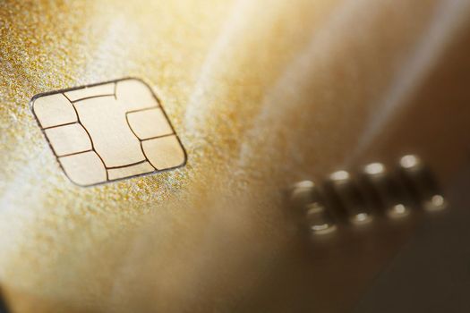 Gold credit card with micro chip selective focus